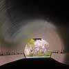 The pink of cherry blossoms reflecting on the tunnel wall on the approach to MIHO Museum